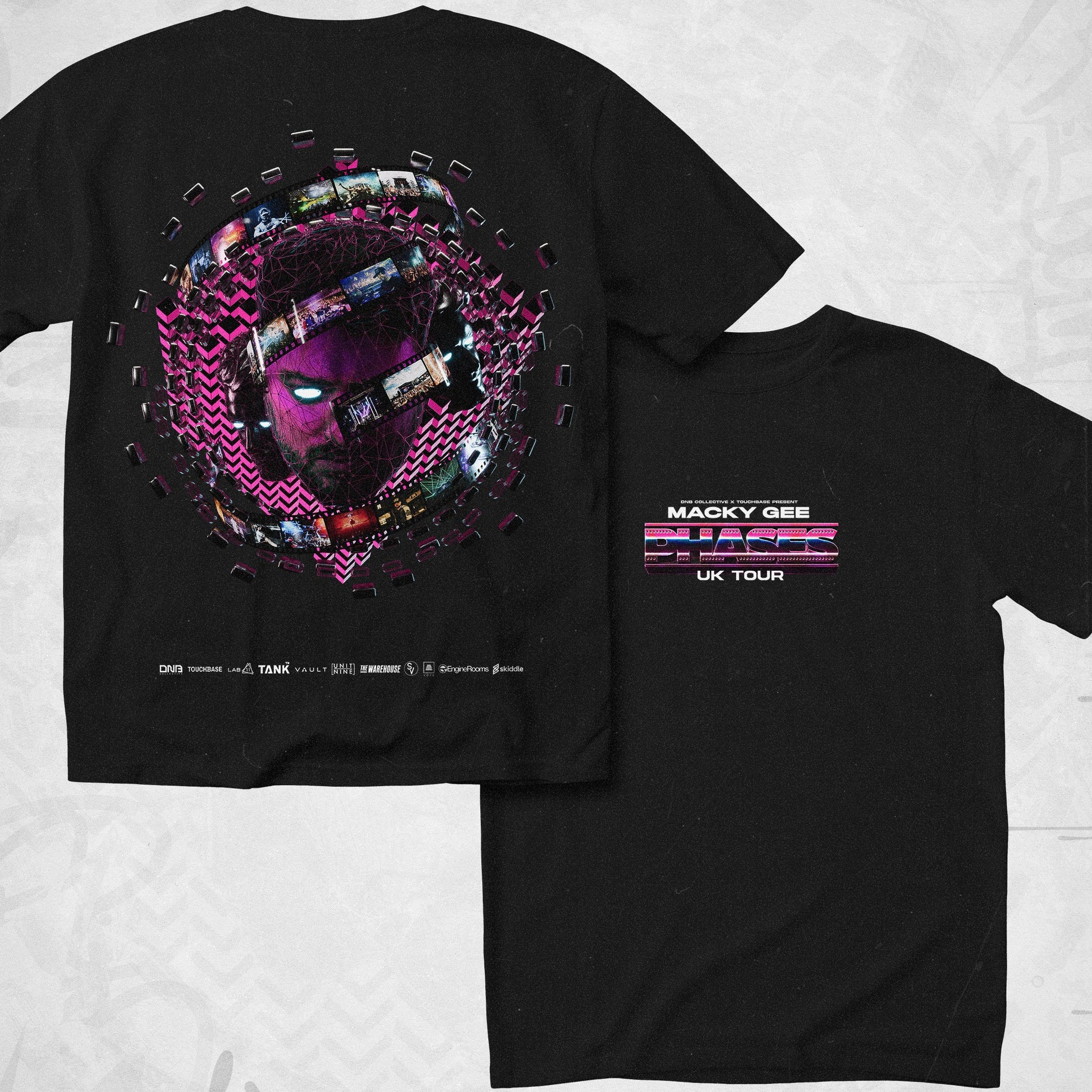 Black t-shirt with colorful graphic design on the front and text on the back, laid flat on a light gray surface.